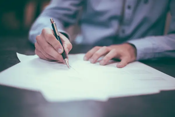 Financial planning content strategy meeting with compliance documents on conference table